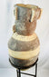 Ancient Peruvian effigy urn featuring detailed headdress and geometric decoration