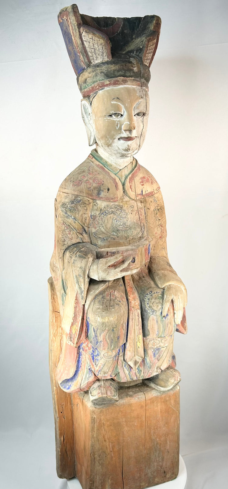 Chinese temple sculpture of a seated scholar-official with remnants of original pigment.