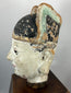 Antique Chinese terracotta official figure with elongated ears and painted features.