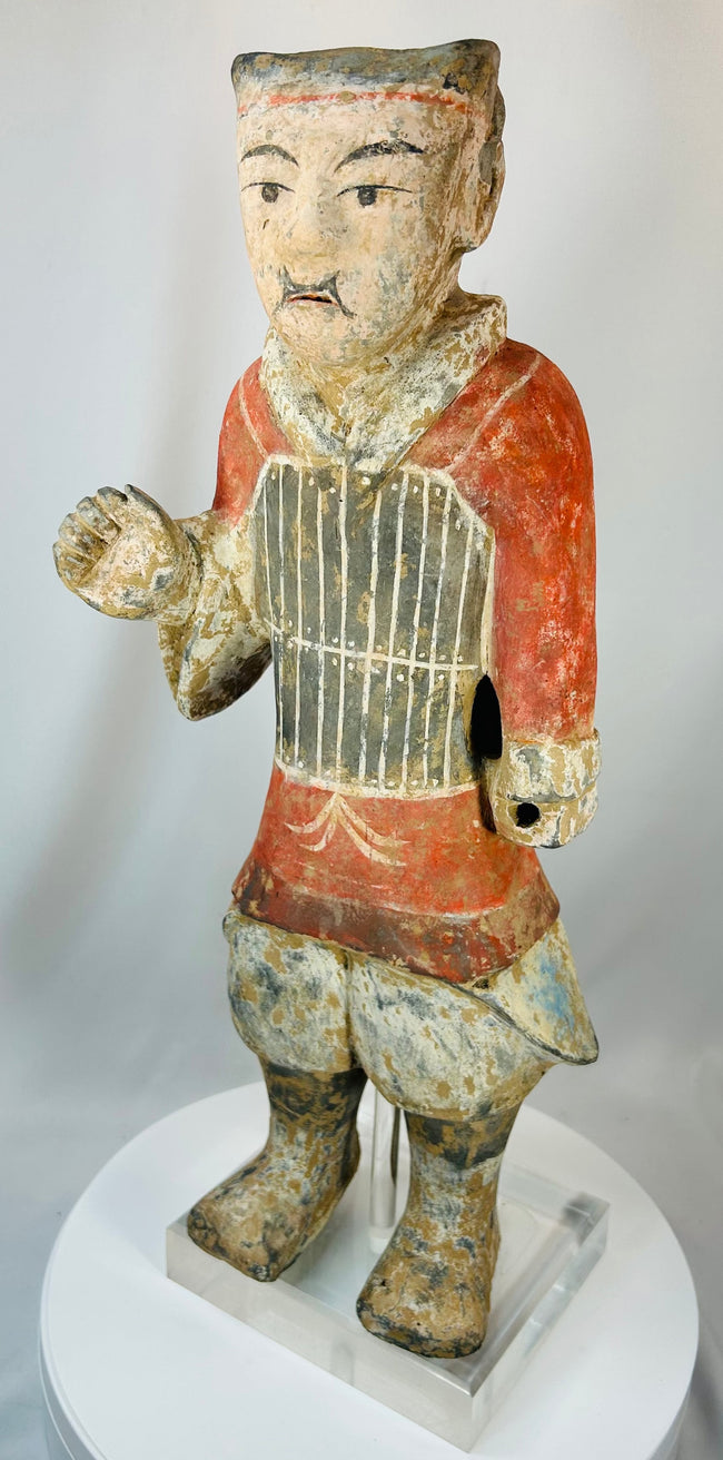 Han period terracotta warrior with expressive face and preserved paint remnants
