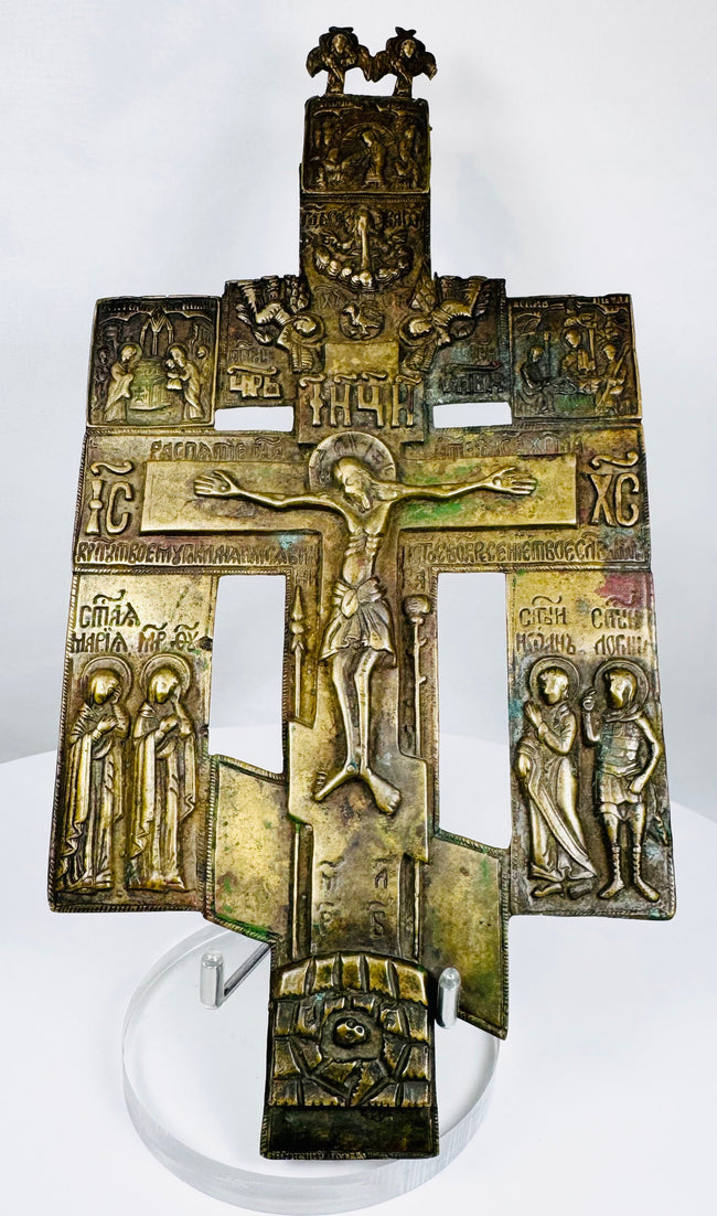 Cast bronze Russian Orthodox cross icon with multiple saintly figures and centuries-old patina.