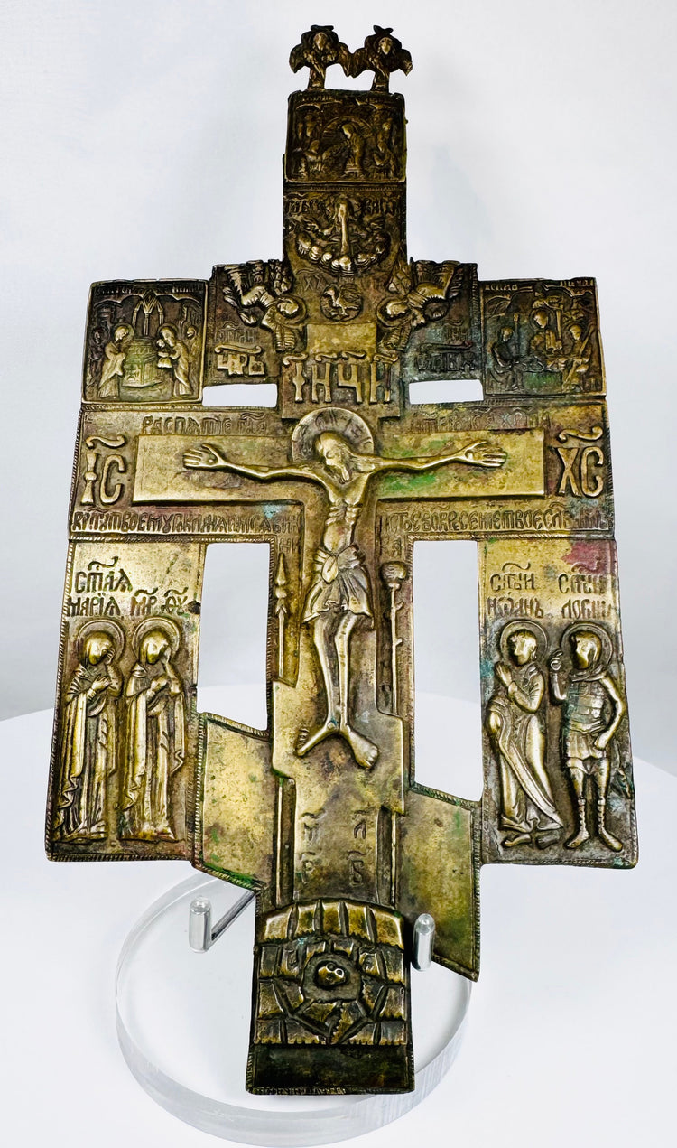Cast bronze Russian Orthodox cross icon with multiple saintly figures and centuries-old patina.