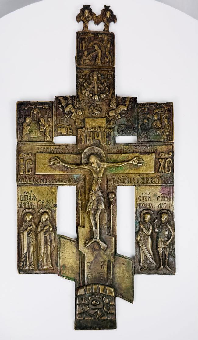 Antique bronze Orthodox cross from Russia displaying detailed religious imagery and devotional craftsmanship.