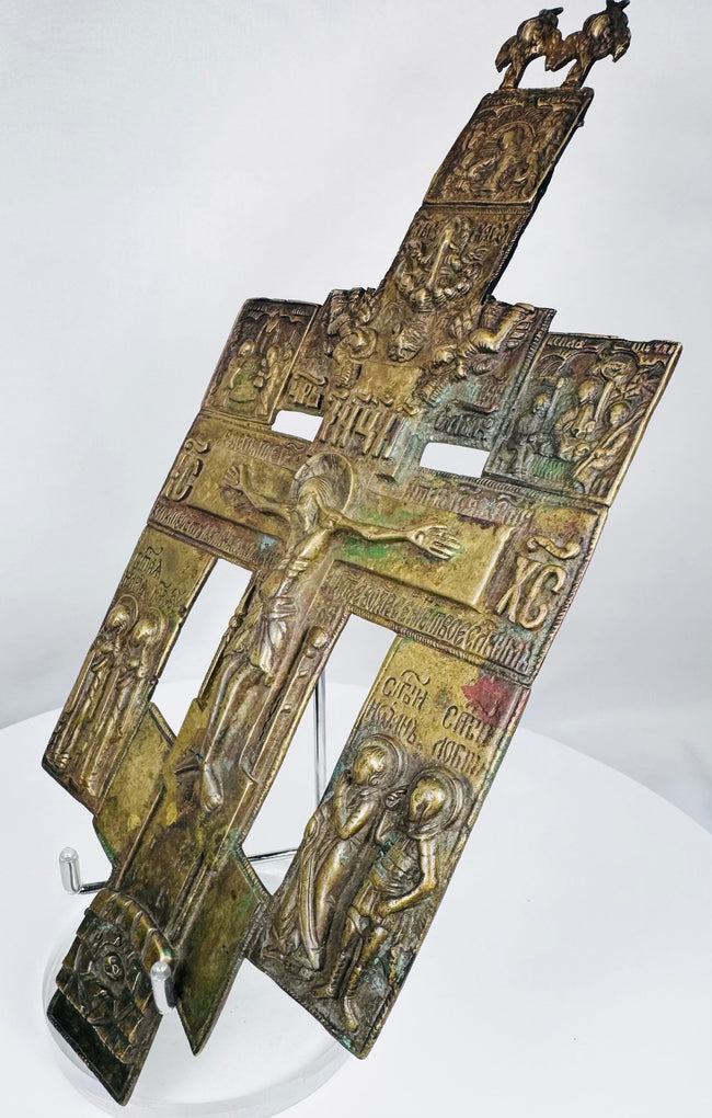 Antique Orthodox bronze crucifix icon from Imperial Russia with rich patina and detailed iconographic program.