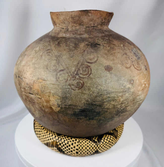 Handcrafted earthenware container from the Timor region with indigenous decorative designs