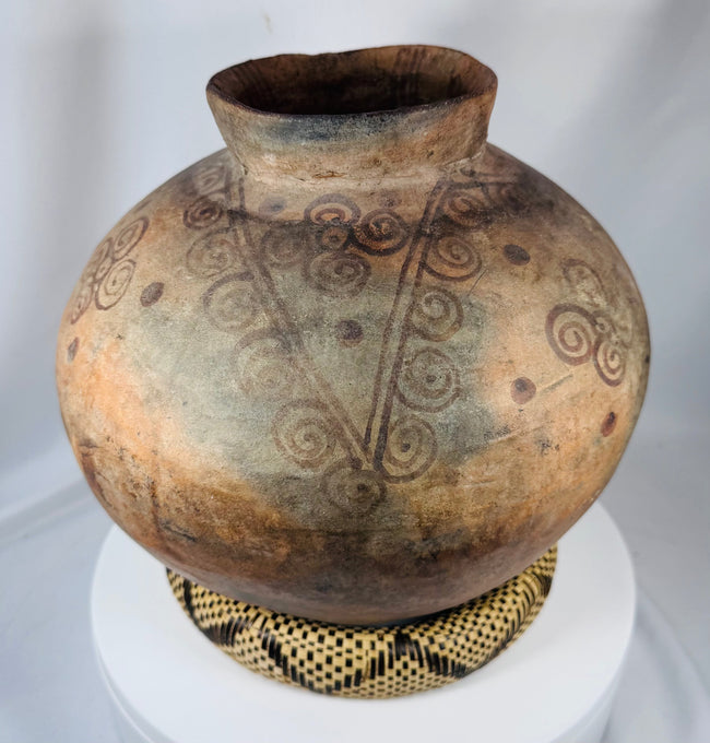 Large ethnographic pottery vessel from Timor-Leste with spiral ornamentation and aged earthenware finish