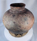Antique Timor storage vessel featuring hand-painted scroll motifs and warm earthen patina