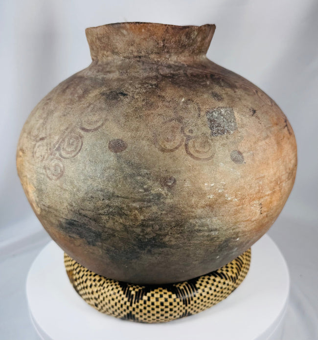 Antique Southeast Asian storage vessel with painted motifs and richly weathered ceramic surface