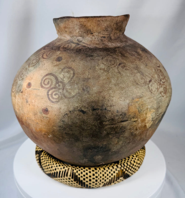 Antique Southeast Asian ceramic storage jar with rich aged surface and decorative spiral banding