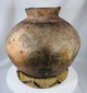 Antique Southeast Asian ceramic storage jar with rich aged surface and decorative spiral banding