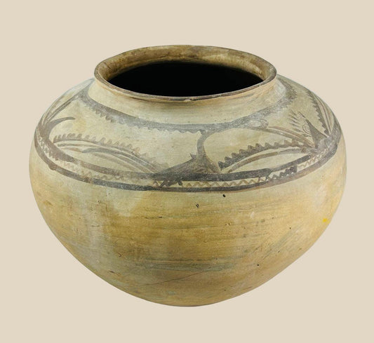 Large Neolithic painted storage jar, circa 5500–4500 BCE, with wide body, narrow rim, and geometric motifs in dark pigment on earthenware surface.