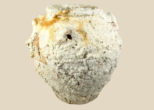 Large Song Dynasty terracotta storage jar recovered from Southeast Asian shipwreck waters, heavily encrusted with marine calcifications, showing wide rounded body and tapered neck for storing liquids or grains