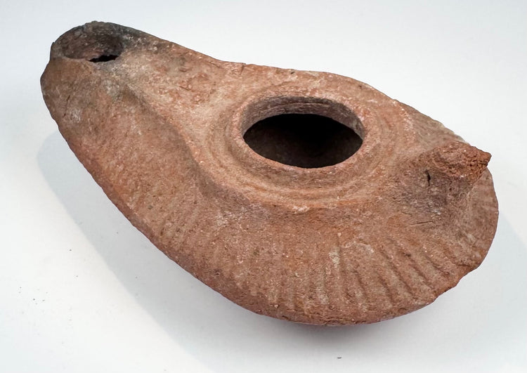 Slipper-shaped terracotta lamp with large filling aperture and worn handle