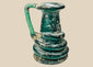 Late Roman blue-green glass jug with applied coiled trail decoration and iridescent burial patina