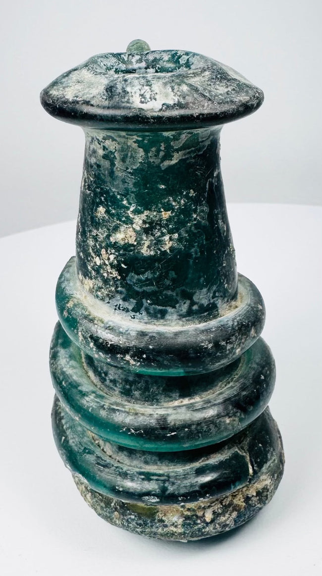 Ancient Roman blue-green glass vessel with applied trail ornament and pronounced archaeological patina