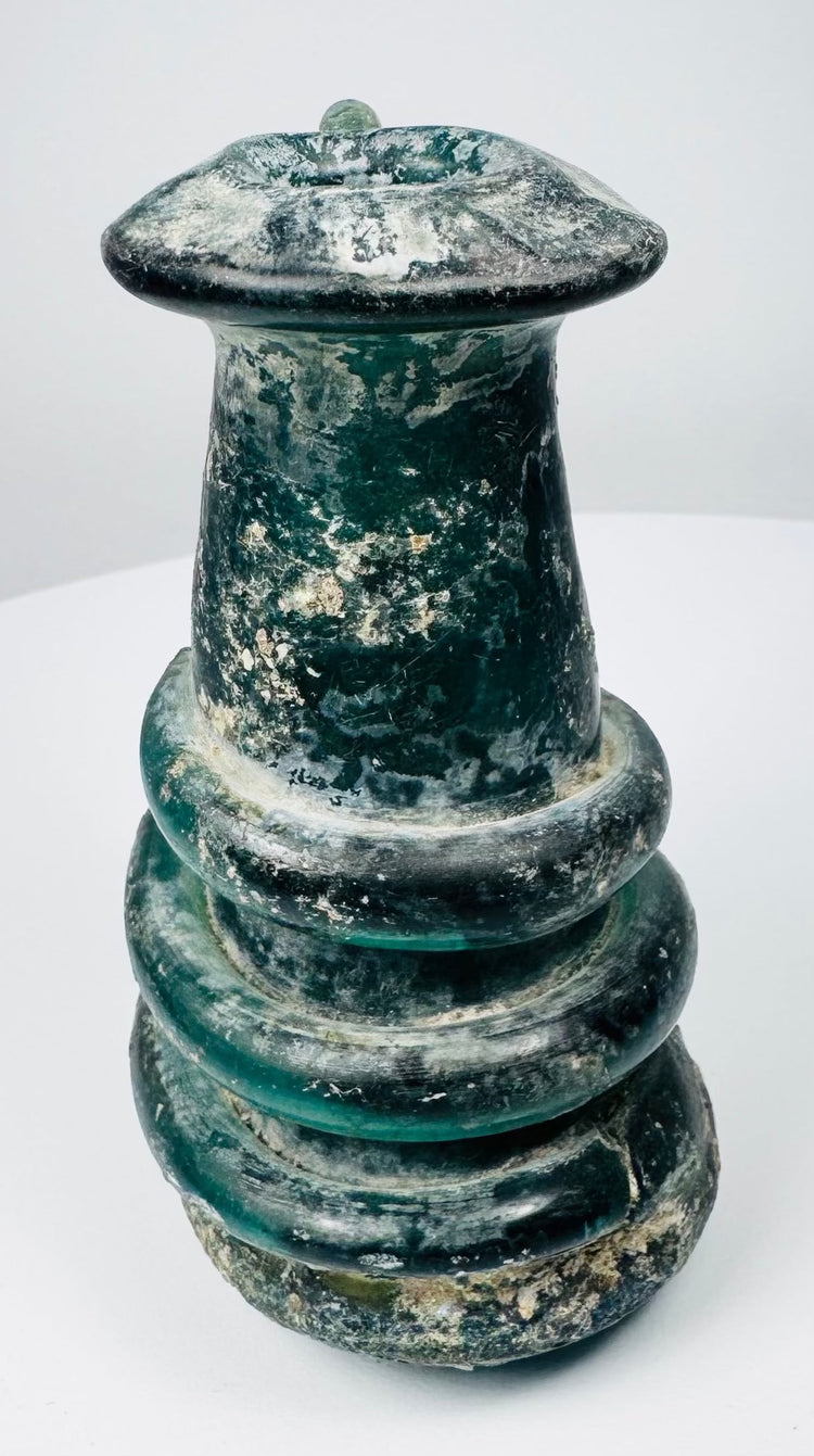 Ancient Roman blue-green glass vessel with applied trail ornament and pronounced archaeological patina