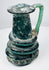 Ancient Roman blown-glass jug with rounded body, tall neck, and applied green glass handle