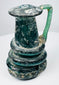 Ancient Roman blown-glass jug with rounded body, tall neck, and applied green glass handle