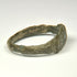 Rear view of ancient Roman bronze finger ring with irregular archaeological surface and surviving patina
