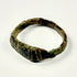 Roman Imperial bronze finger ring showing vertical grooves, diagonal incisions, and mineral deposits