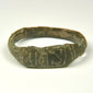 Ancient Roman bronze ring showing broad flattened bezel with incised vertical and diagonal decoration