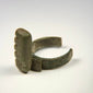 Ancient Roman ring key with substantial copper-alloy construction, dark patina, and preserved four-tooth locking profile