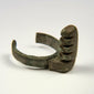 Ancient Roman copper-alloy ring key showing a substantial projecting lock mechanism and open-ended band