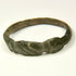 Late Antique bronze finger ring with solid cast hoop, expanding shoulders, and geometric incisions