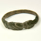Late Antique bronze finger ring with solid cast hoop, expanding shoulders, and geometric incisions