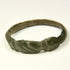 Side view of Late Roman bronze ring showing geometric shoulder grooves and worn archaeological surface