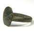 Close-up of Byzantine bronze signet ring with weathered incised cruciform bezel and naturally aged surface