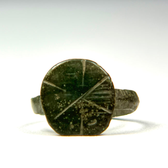 Front view of Late Roman bronze signet ring showing incised cruciform and geometric bezel decoration