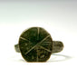 Front view of Late Roman bronze signet ring showing incised cruciform and geometric bezel decoration