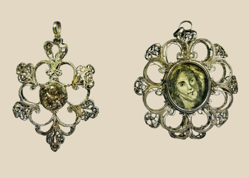 Antique 19th-century Catholic devotional pendant with ornate silver filigree frame and engraved portrait of Christ under glass, likely Italian or Spanish origin.