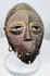 Mid-20th century Lega passport mask with triangular nose, understated mouth, and ritual wear.
