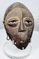 Mid-20th century Lega passport mask with triangular nose, understated mouth, and ritual wear.