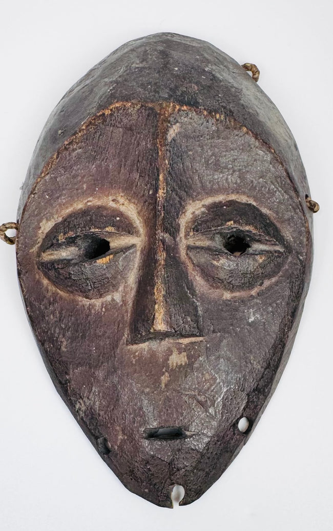 Authentic Lega passport mask featuring elongated facial form and stylized almond-shaped eyes.