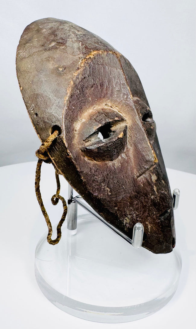 Compact Lega passport mask used as a personal insignia within the Bwami initiation system.