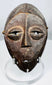 Wooden Lega devotional mask from the Democratic Republic of the Congo with rich dark patina.