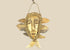 Mid-20th-century Lega tribal pendant mask from the Congo, carved bone face with braided fiber collar, wood backing, and hanging cord, displayed on a black stand against a white background.