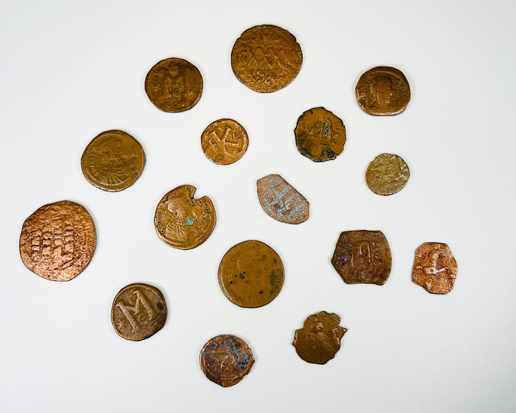 Sixteen authentic late antiquity coins with varied flan shapes and aged surfaces