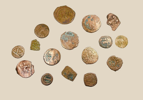 Collection of 16 ancient Roman and Byzantine bronze coins, circa 2nd–7th century AD, featuring worn imperial busts, Christian symbols, and reverse motifs; varied sizes and patinas with green oxidation and surface wear, representing authentic currency circulation across late antiquity and the early Byzantine Empire.