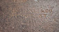 Close-up of the M.H. Jones & Co. maker’s mark stamped into the forged steel of the 19th-century axe head.