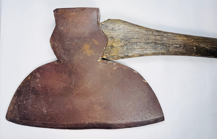 Full-length 19th-century M.H. Jones & Co. broad axe with long wooden handle and wide forged steel cutting head.