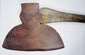 Full-length 19th-century M.H. Jones & Co. broad axe with long wooden handle and wide forged steel cutting head.