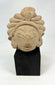 Kala Simha guardian head from a Majapahit-era temple, volcanic stone carving, Java, 14th–15th century