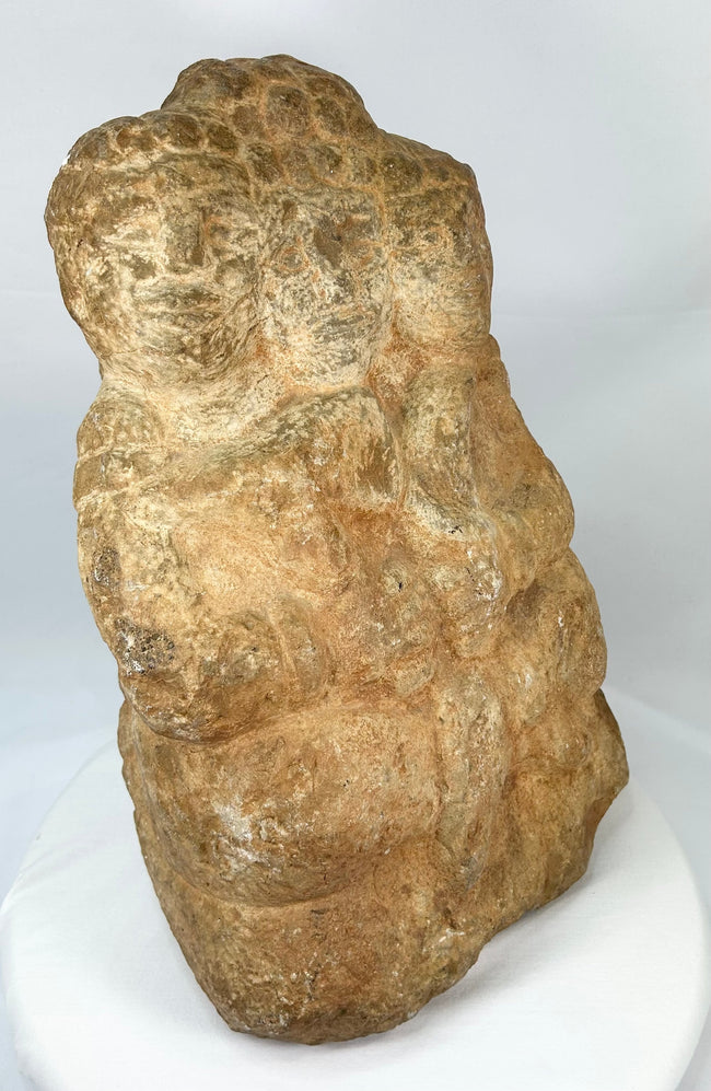 Side view of Majapahit three-faced Brahma stone sculpture, 14th–15th century Java, Indonesia, carved from volcanic andesite with natural patina and temple wear.