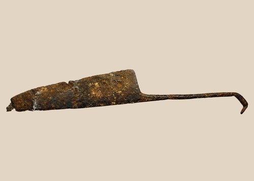 Heavily corroded medieval iron long knife with wide single-edged blade and rough rust texture