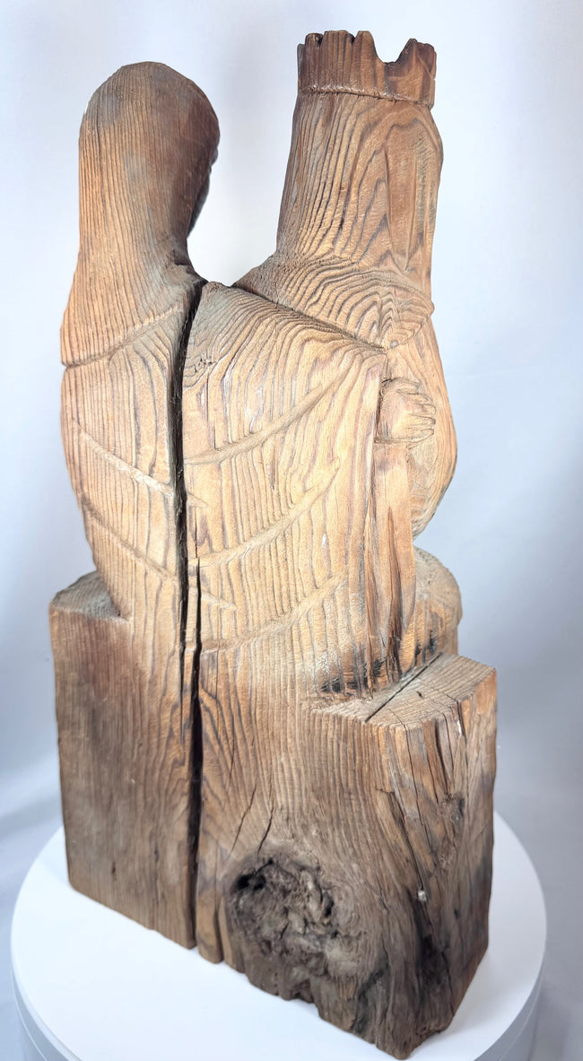 Gothic Revival ecclesiastical carving showing the Holy family in a seated devotional composition