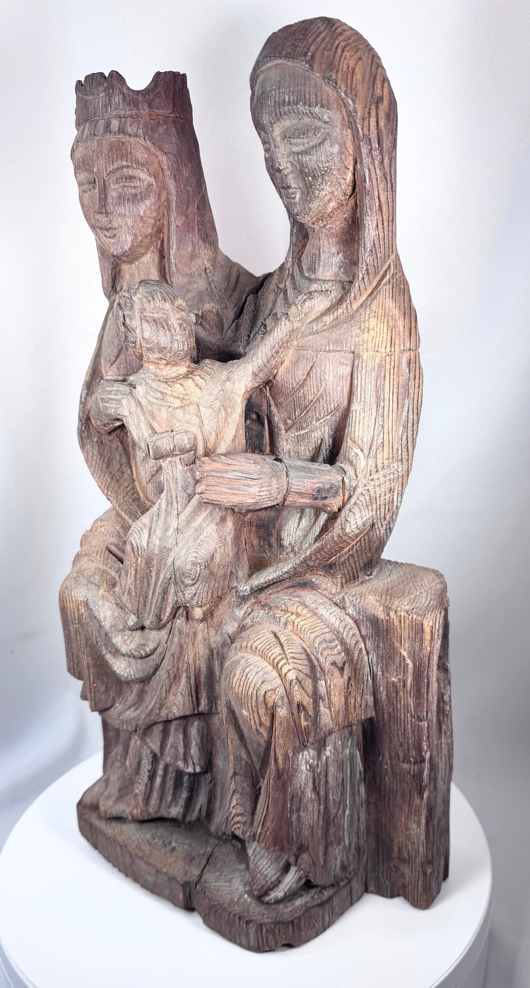 European religious wood carving with elongated Gothic facial features and flowing drapery
